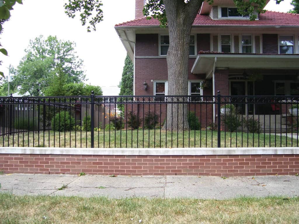 Set up a Hamilton County Wrought Iron Fence with Bullseye Fence Design image shows fence on yard above sidewalk