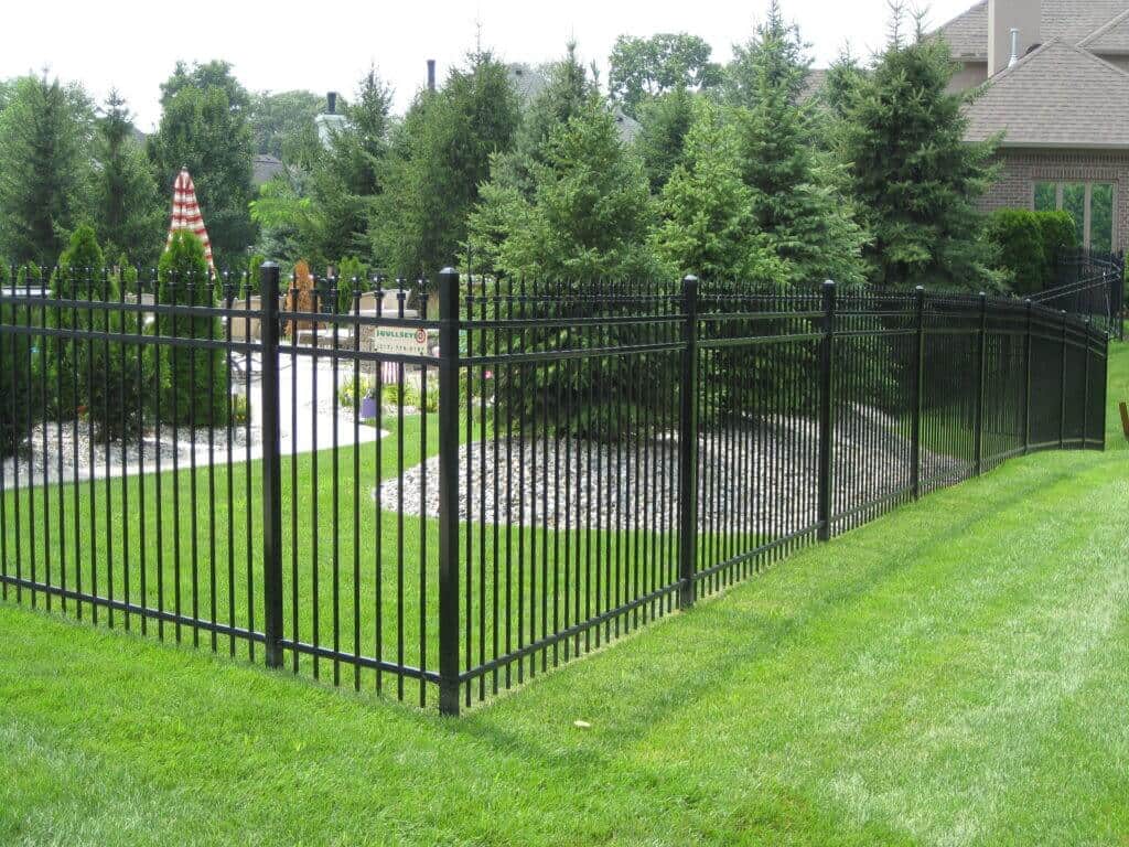 Equip your property with a Carmel Aluminum Fence with help from Bullseye Fence Design image shows corner of fence on grass